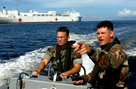 US Navy 070922-N-0194K-536 Lt.j.g. Mike Porfirio, left, and Master-at-Arms 3rd Class Pablo Ordonez conduct a security patrol in the waters around Military Sealift Command hospital ship USNS Comfort (T-AH 20)