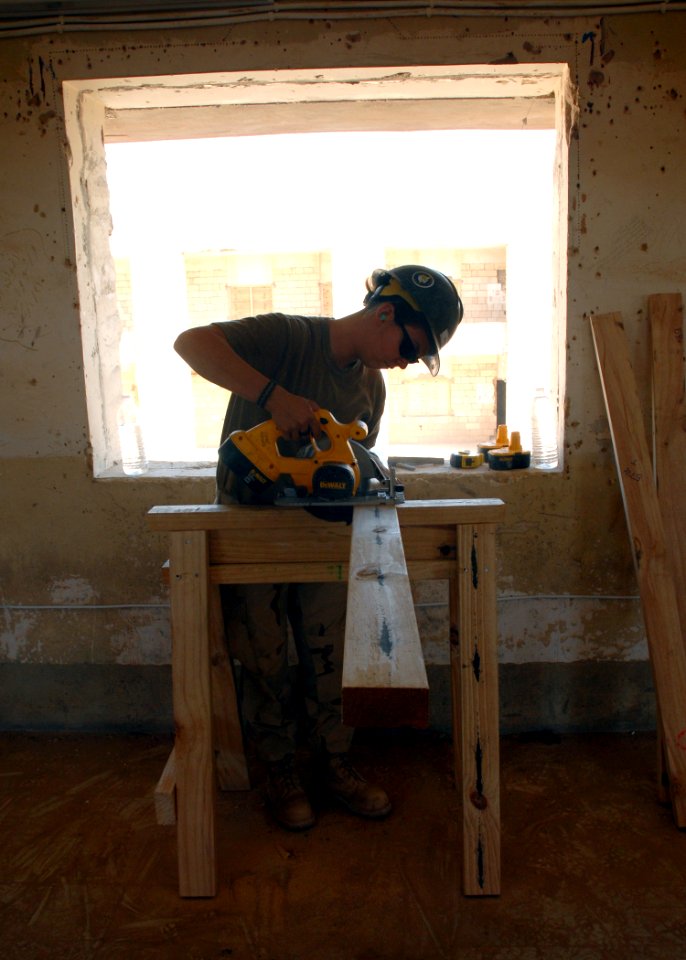 US Navy 070922-N-3560G-017 Construction Electrician Constructionman Jennifer McGhee, attached to Naval Mobile Construction Battalion (NMCB) 4, cuts window framing during the conversion of an old Iraqi prison