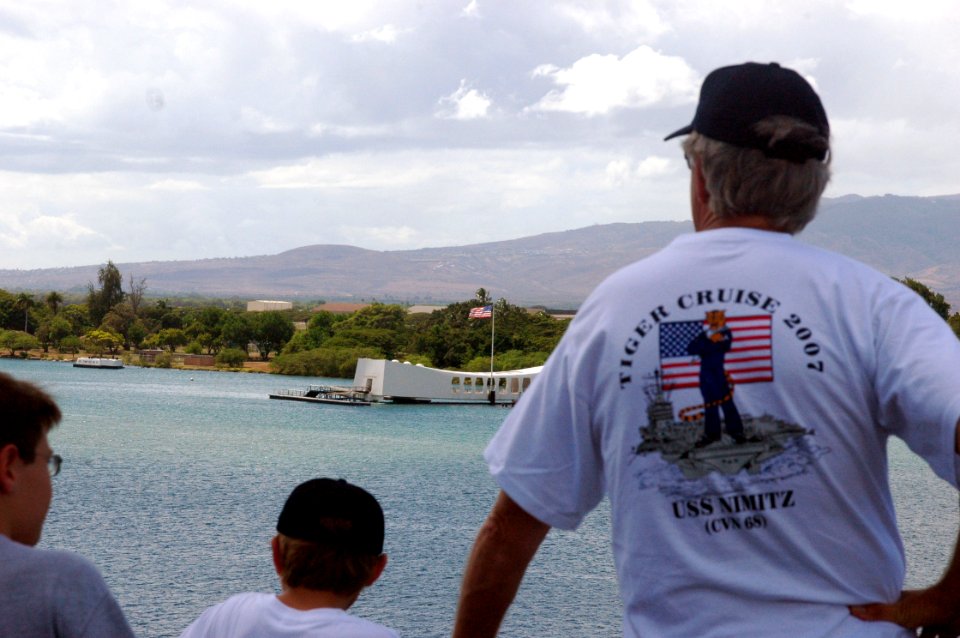 US Navy 070924-N-5148B-051 A father and his son look out at the USS Arizona Memorial as nuclear-powered aircraft carrier USS Nimitz (CVN 68) departs Pearl Harbor on a Tiger Cruise