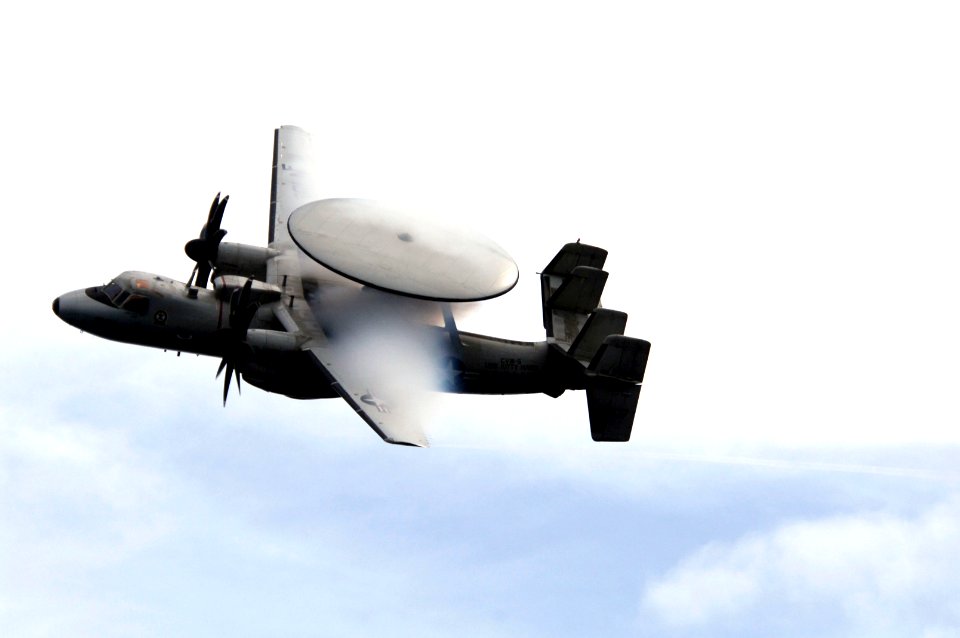 US Navy 070923-N-3136P-023 Water vapor flows over the wings of an E-2C Hawkeye while performing a flyby during an air power demonstration