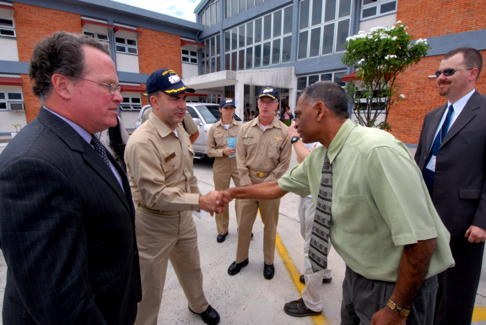 US Navy 070924-N-8704K-019 From left, David Robinson, U.S. ambassador to Guyana, and Capt. Bob Kapcio, mission commander for Military Sealift Command hospital ship USNS Comfort (T-AH 20), are greeted by Dr. Leslie Ramsammy, Guy