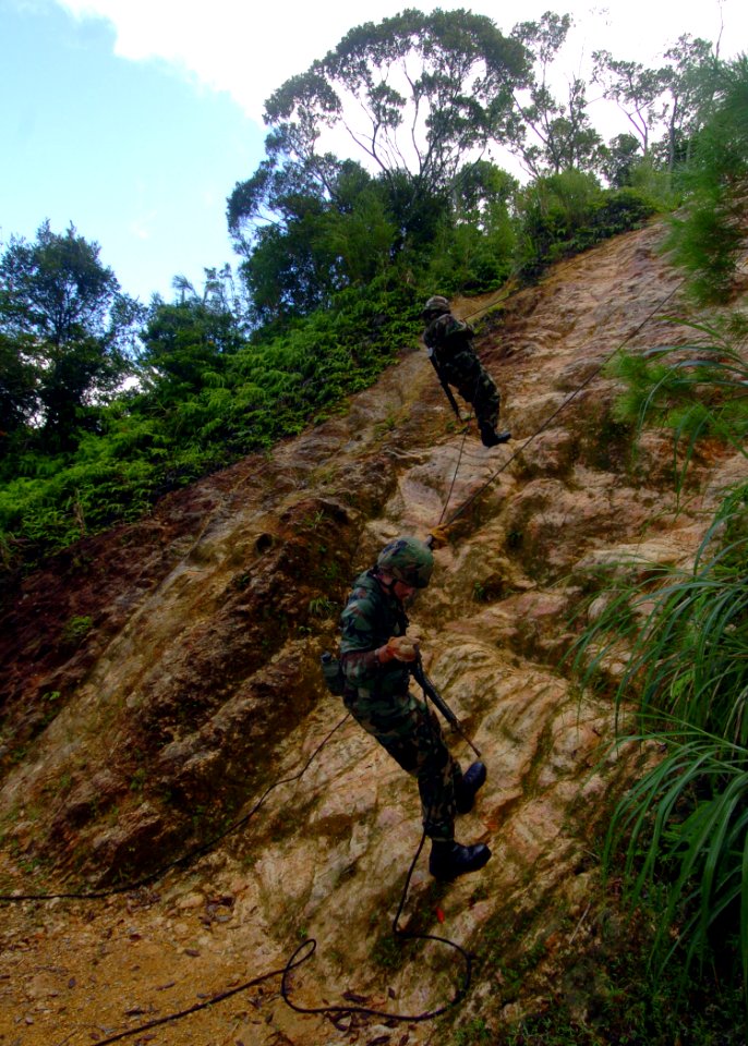 US Navy 070927-N-4267W-011 Seabees with Naval Mobile Construction Battalion (NMCB) 7 repel down a cliff during a jungle warfare training evolution hosted by Marines with the Jungle Warfare Training Command (JWTC)