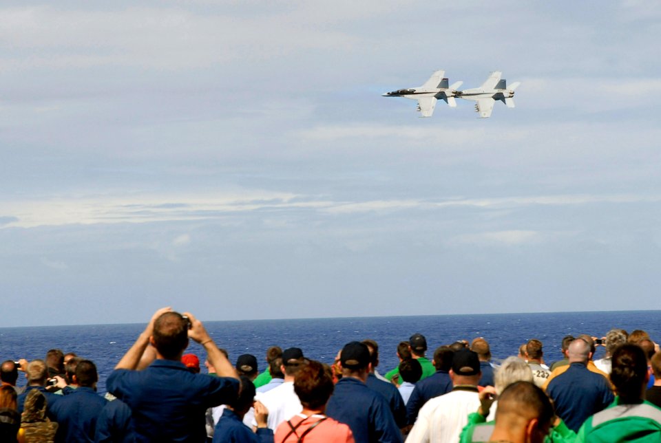 US Navy 070926-N-0890S-009 Two F-A-18F Super Hornets, assigned to the Black Aces of Strike Fighter Squadron (VFA) 41, fly by the flight deck during a Tiger Cruise air power demonstration