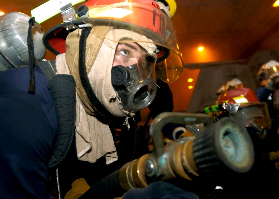 US Navy 070927-N-5681S-012 Boatswain's Mate 3rd Class Cory Barber, of Traverse City, Mich., simulates fighting a mock fire aboard nuclear-powered aircraft carrier USS Enterprise (CVN 65) during a general quarters drill