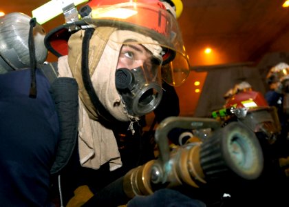 US Navy 070927-N-5681S-012 Boatswain's Mate 3rd Class Cory Barber, of Traverse City, Mich., simulates fighting a mock fire aboard nuclear-powered aircraft carrier USS Enterprise (CVN 65) during a general quarters drill