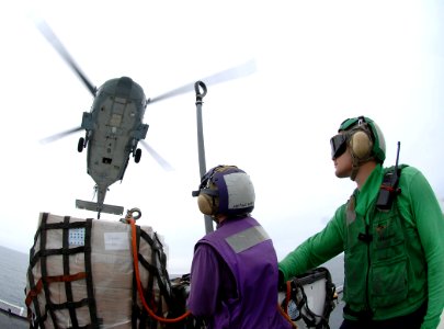 US Navy 070923-N-0194K-036 Two Sailors prepare to secure cargo to an MH-60S Seahawk, attached to Helicopter Sea Combat Squadron (HS) 28, to support a Military Sealift Command hospital ship USNS Comfort (T-AH 20) humanitarian mi photo