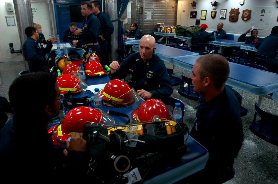 US Navy 070928-N-4014G-196 Command Master Chief Dominick Musso speaks with Information Systems Technician Seaman Dennis Figueroa and Seaman Justin Martin about various firefighting techniques aboard guided-missile destroyer USS