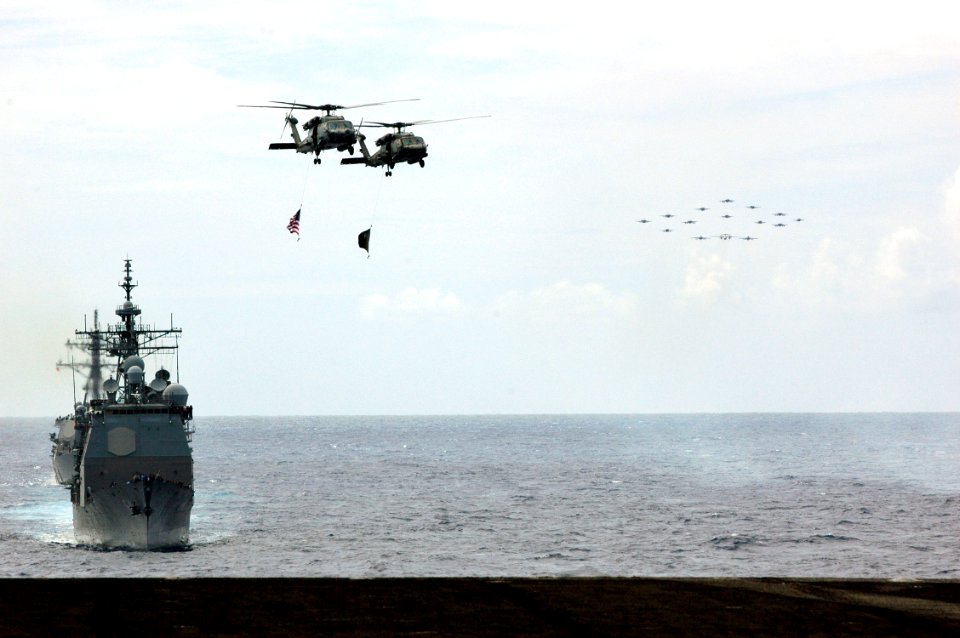 US Navy 070926-N-7128A-054 Two SH-60F Seahawks, assigned to the Indians of Helicopter Anti-submarine Squadron (HS) 6, fly over Carrier Strike Group (CSG) 11 ships