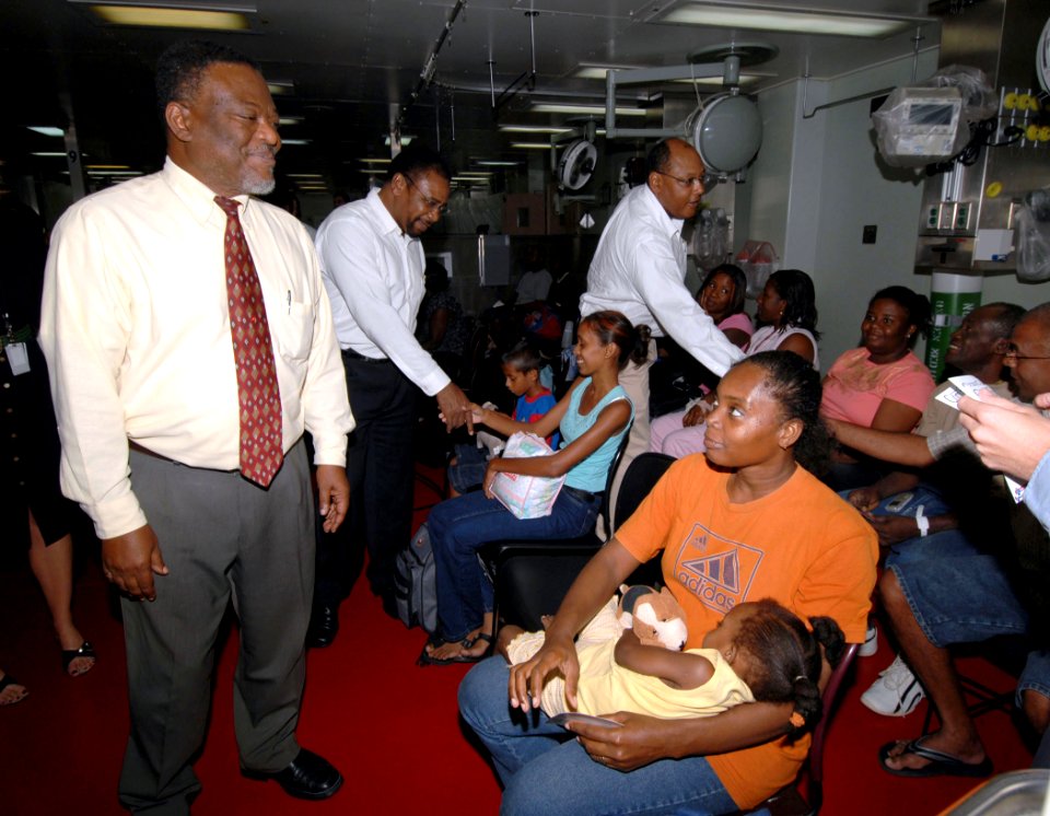 US Navy 070928-N-7088A-092 Guyana's Prime Minister Samuel Hinds speaks with patients waiting to be seen by medical personnel aboard Military Sealift Command hospital ship USNS Comfort (T-AH 20)