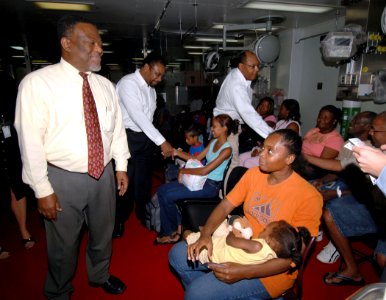 US Navy 070928-N-7088A-092 Guyana's Prime Minister Samuel Hinds speaks with patients waiting to be seen by medical personnel aboard Military Sealift Command hospital ship USNS Comfort (T-AH 20) photo