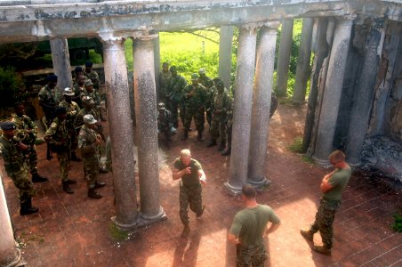 US Navy 070925-N-0989H-348 Cpl. Ehren Bentz, assigned to a mobile training team, center, demonstrates Close Quarters Battle and room clearing techniques for members of the Jamaica Defense Force during small unit training photo