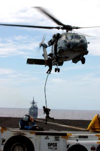 US Navy 070926-N-7128A-030 Sailors assigned to Explosive Ordnance Disposal Mobile Unit (EODMU) 11, Det. 3, rappel onto the flight deck of the nuclear-powered aircraft carrier USS Nimitz (CVN 68)