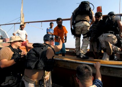 US Navy 070926-N-0841E-060 Boarding team members from the guided-missile frigate USS Carr (FFG 52) render assistance to a United Arab Emirates-flagged fishing dhow as part of an interaction patrol