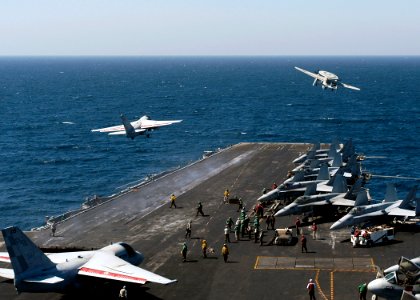 US Navy 070927-N-5681S-013 An E-2C Hawkeye, attached to Carrier Airborne Early Warning Squadron (VAW) 123, and an EA-6B Prowler, attached to Electronic Attack Squadron (VAQ) 137, launch from the flight deck of nuclear-powered a