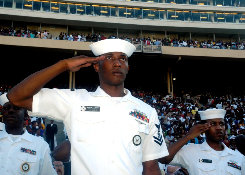US Navy 070929-N-5208T-008 Sailors assigned to Navy Recruiting District Dallas salute during the national anthem at the Cotton Bowl for the Texas State Fair Football Classic. This event was held in conjunction with Dallas Navy