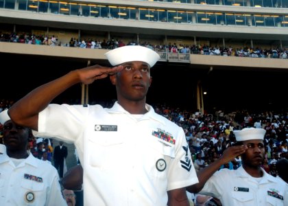 US Navy 070929-N-5208T-008 Sailors assigned to Navy Recruiting District Dallas salute during the national anthem at the Cotton Bowl for the Texas State Fair Football Classic. This event was held in conjunction with Dallas Navy