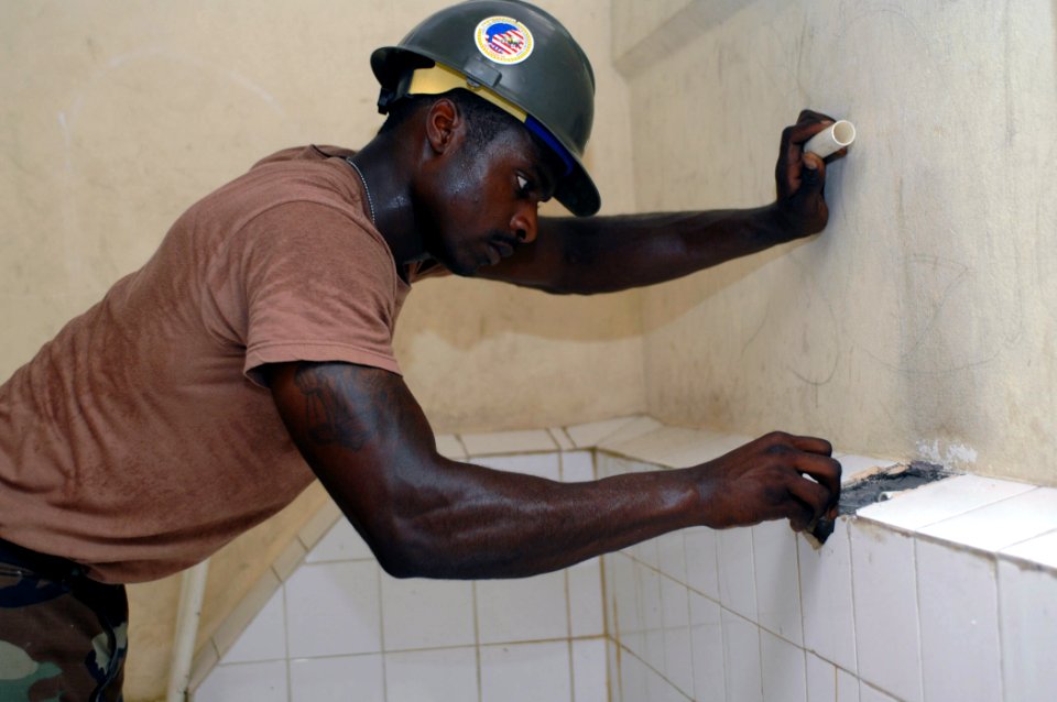 US Navy 070926-N-7088A-565 Utilitiesman 2nd Class Charlie King, a Seabee with Construction Battalion Maintenance Unit (CBMU) 202 attached to Military Sealift Command hospital ship USNS Comfort (T-AH 20), restores plumbing in a photo