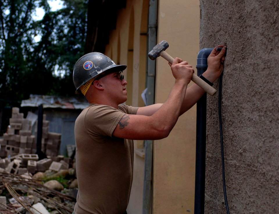 US Navy 071004-N-1003P-002 Construction Electrician 3rd Class Todd Delquardi does some last-minute tweaking so he can begin the electrical wiring for the administration building that is under construction at the Abiot Ermeja Sc