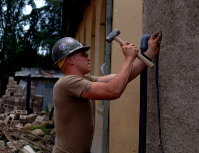US Navy 071004-N-1003P-002 Construction Electrician 3rd Class Todd Delquardi does some last-minute tweaking so he can begin the electrical wiring for the administration building that is under construction at the Abiot Ermeja Sc