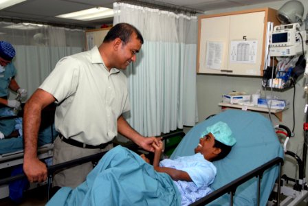 US Navy 070929-N-8704K-038 President of Guyana Bharrat Jagdeo greets a patient during a tour of Military Sealift Command hospital ship USNS Comfort (T-AH 20) photo