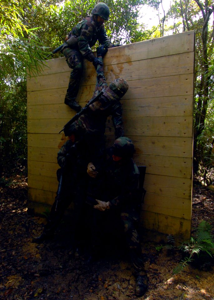 US Navy 070927-N-4267W-071 Seabees with Naval Mobile Construction Battalion (NMCB) 7 work together to climb over a wall during a jungle warfare training evolution hosted by Marines with the Jungle Warfare Training Command (JWTC