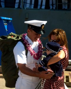 US Navy 070928-N-0995C-044 Chief Cryptologic Technician Davy Feller greets his wife and child after returning to Naval Station Pearl Harbor from deployment aboard guided-missile cruiser USS Chosin (CG 65)