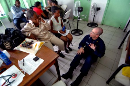US Navy 071005-N-0194K-137 U.S. Coast Guard Lt. Cmdr. Jeff Salvon-Harman, a doctor with U.S. Public Health Service and attached to the Military Sealift Command hospital ship USNS Comfort (T-AH 20), demonstrates exercises to all photo