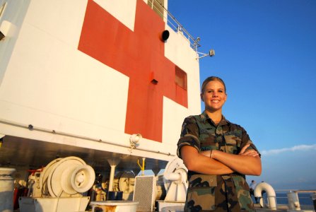 US Navy 071002-N-0194K-100 U.S. Air Force Staff Sgt. Sarah Boyll, a dental technician attached to Military Sealift Command hospital ship USNS Comfort T-AH 20), poses for a photo on the ship's fantail photo