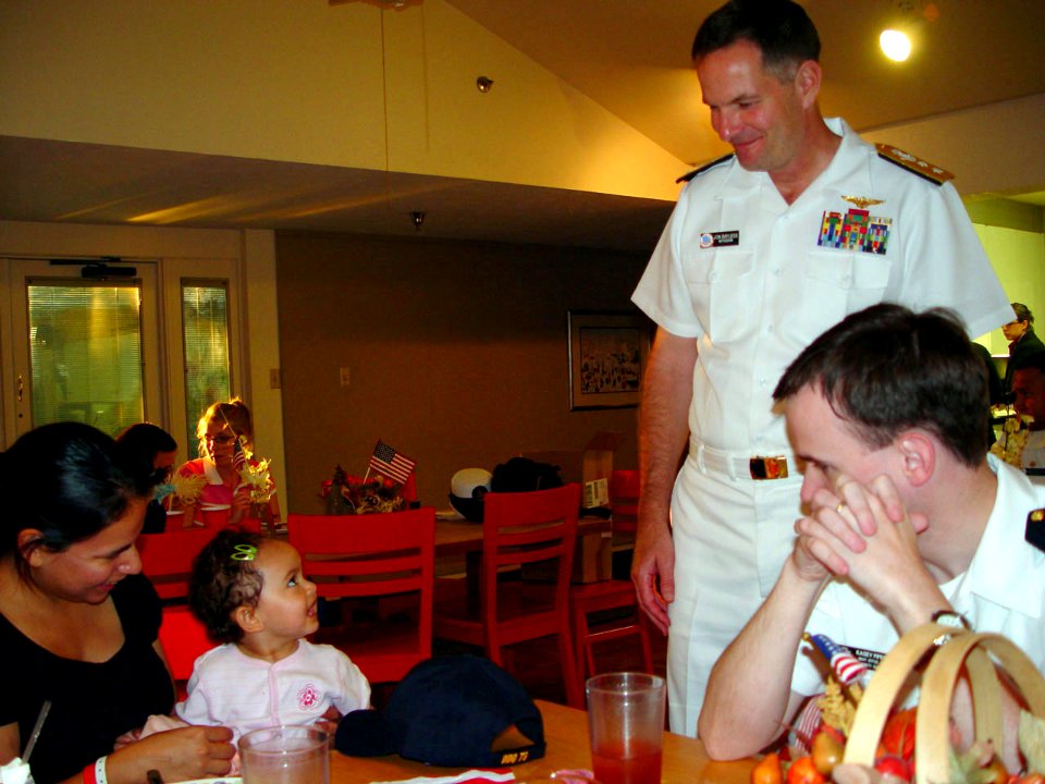 US Navy 071003-N-2888Q-008 Rear Adm. Jon W. Bayless Jr., commander of Navy Region Midwest, smiles after giving a Navy ball cap to a young girl at the Ronald McDonald House of Dallas