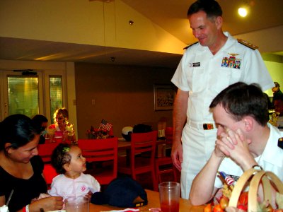 US Navy 071003-N-2888Q-008 Rear Adm. Jon W. Bayless Jr., commander of Navy Region Midwest, smiles after giving a Navy ball cap to a young girl at the Ronald McDonald House of Dallas