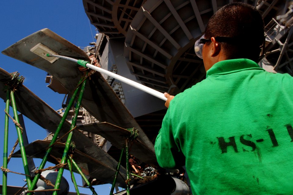 US Navy 070929-N-5928K-006 Airman Mhaynard Dionido, of Ventura, Calif., scrubs a propeller blade on an SH-60F Seahawk