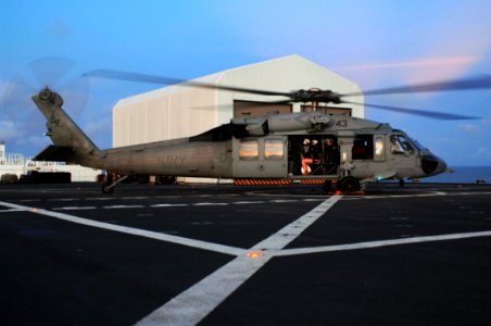 US Navy 071007-N-7088A-077 The last patients to receive care aboard the Military Sealift Command hospital ship USNS Comfort (T-AH 20), board an MH-60S helicopter in preparation to depart the ship photo