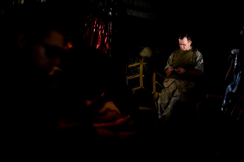 US Navy 071004-N-0696M-032 Adm. Mike Mullen, chairman of the Joint Chiefs of Staff, checks his emails en route to Forward Operating Base Marez