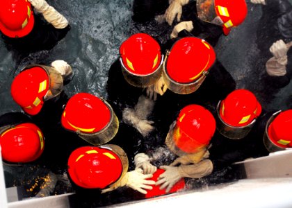 US Navy 071004-N-2638R-001 Sailors attached to the Avenger-class mine warfare ship USS Guardian (MCM 5) work together to apply a box plug to a casualty in Afloat Training Group, Western Pacific's damage control wet traine