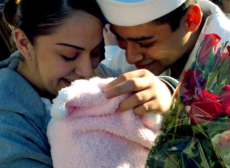 US Navy 071008-N-4163T-087 Gunner's Mate 3rd Class Mario Rodriguez greets his wife and newborn daughter during a homecoming celebration for guided-missile destroyer USS Milius (DDG 69)