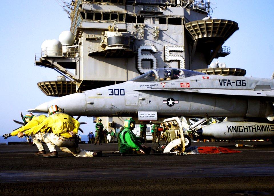 US Navy 071005-N-5681S-057 Flight deck officers launch an F-A-18C Hornet, attached to the Knighthawks of Strike Fighter Squadron VFA) 136, from the flight deck of the nuclear-powered aircraft carrier USS Enterprise (CVN 65)