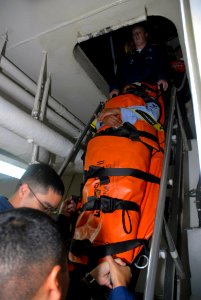 US Navy 071026-N-1635S-002 Medical department personnel transport a simulated victim down a ladder during a drill aboard Nimitz-class aircraft carrier USS Ronald Reagan (CVN 76) photo