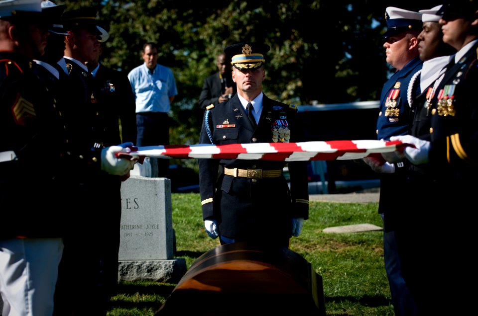 US Navy 071031-N-0696M-229 The joint service honor guard prepares to fold the national ensign during the memorial service for Adm. William J. Crowe, 11th Chairman of the Joint Chiefs of Staff, who died Oct. 18 at the age of 82
