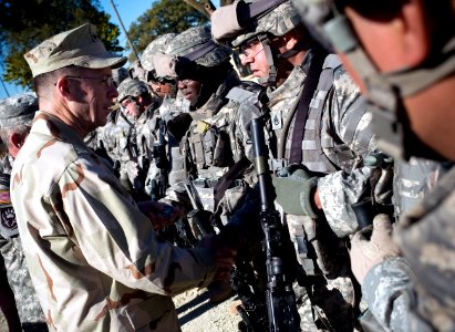 US Navy 071024-N-0696M-553 Chairman of the Joint Chiefs of Staff, U.S. Navy Adm. Mike Mullen greets service members assigned to the military transition team (MiTT) training program on board Fort Riley