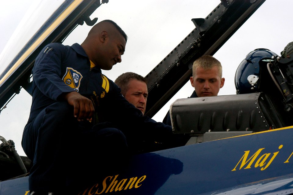 US Navy 071031-N-8102J-019 Brian Schneider, catcher for the Washington Nationals baseball team, receives preflight instructions from the crew chief, Marine Corps Staff Sgt. Deo Harrypersaud, before taking a ride in a Blue Angel