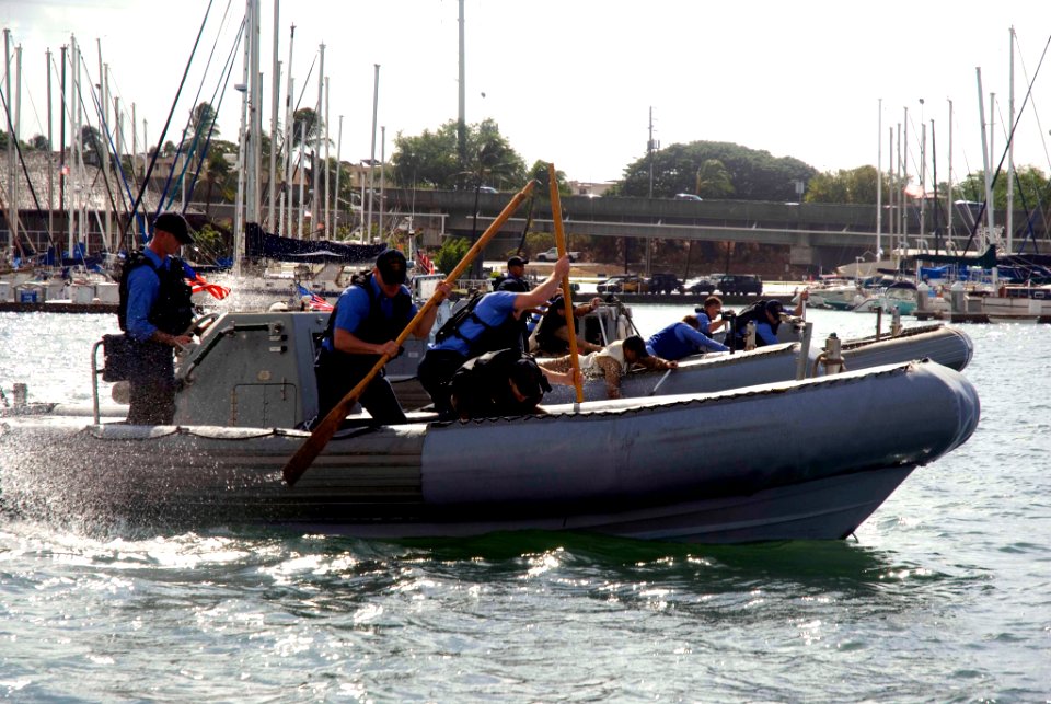 US Navy 071031-N-6674H-003 Sailors paddle their rigid hull inflatable boats (RHIB) at the start of the RHIB Race and Regatta held at Rainbow Bay Marina