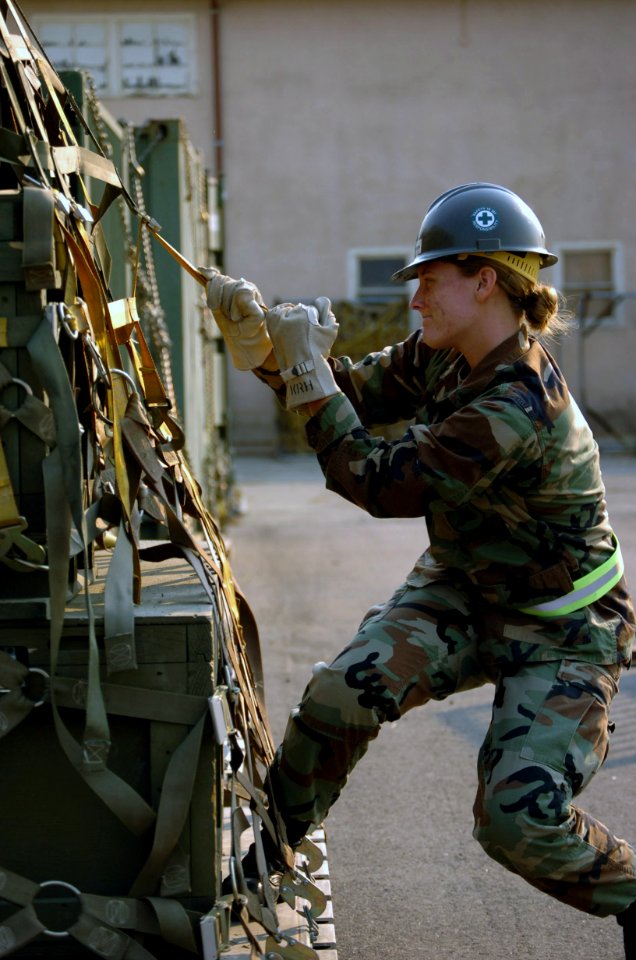 US Navy 071025-N-0775Y-014 Builder 3rd Class Katheryn Henderson pulls on a strap to secure a pallet of supplies during Naval Mobile Construction Battalion (NMCB) 3's embark training evolution, known as Operation Meathook, on bo