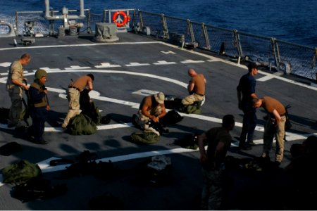 US Navy 071028-N-4014G-002 Members of the visit, board, search, and seizure (VBSS) team aboard guided-missile destroyer USS Porter (DDG 78) prepare their gear in case they must board a pirated vessel