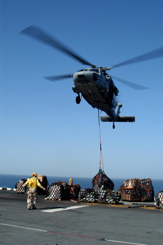US Navy 071031-N-7955L-073 An MH-60S Seahawk assigned to Helicopter Combat Sea Squadron (HSC) 26, drops pallets of supplies onto the flight deck of amphibious assault ship USS Kearsarge (LHD 3)