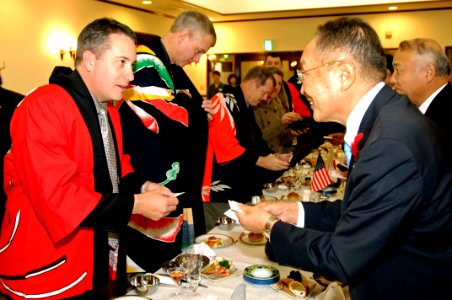 US Navy 071027-N-7883G-050 Cmdr. Dan Dusek, commanding officer of USS Fitzgerald (DDG 62), exchanges business cards with Muroran Mayor Masashi Shingu during a reception held in the Japanese Steel Works reception hall
