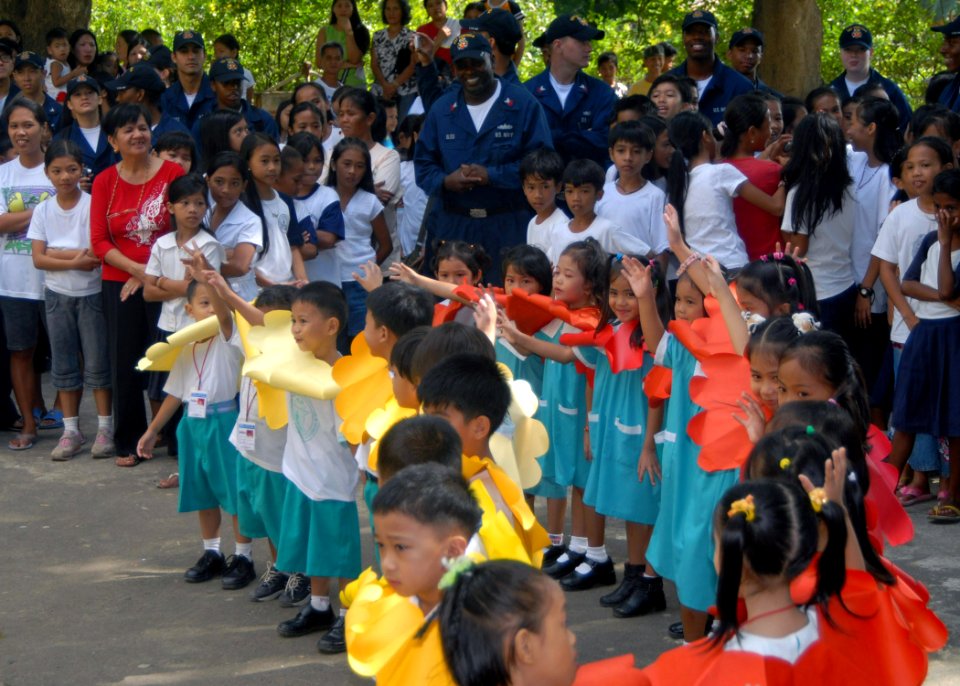 US Navy 071030-N-6710M-032 During a community relations project, USS Tortuga (LSD 46) Sailors observe a show put on by the students of New Cabalan Elementary School
