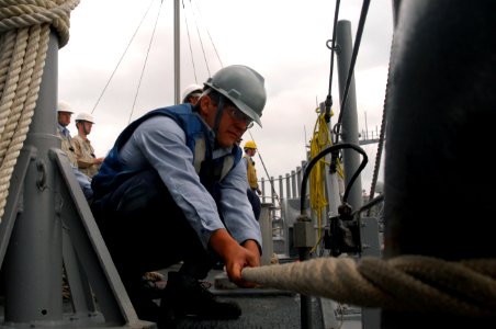 US Navy 071030-N-0807W-044 Mineman Seaman Kyle Rose, assigned to mine warfare ship USS Patriot (MCM 7), helps moor the ship at White Beach, Okinawa