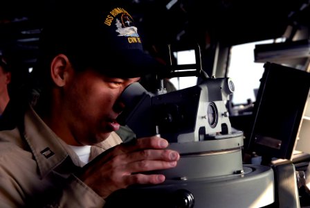 US Navy 071026-N-4776G-124 Lt. Edward Hood uses a telescopic alidade on the bridge of Nimitz-class aircraft carrier USS Ronald Reagan (CVN 76), during a simulated channel transit