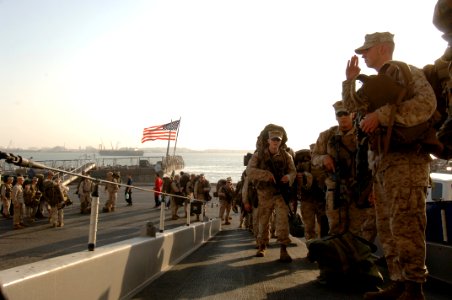 US Navy 071101-N-7027P-115 Marines stop and salute the ensign as they embark onto amphibious assault ship USS Wasp (LHD 1) in preparation for a crisis response exercise