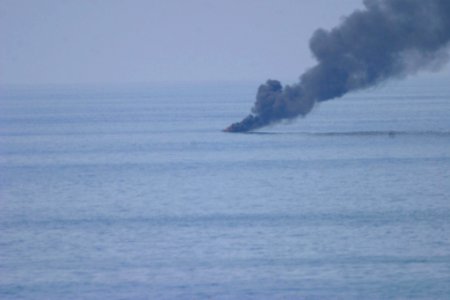 US Navy 071028-N-0000X-185 A pirate skiff burns after being hit by several rounds from a 25mm gun aboard guided-missile destroyer USS Porter (DDG 78)